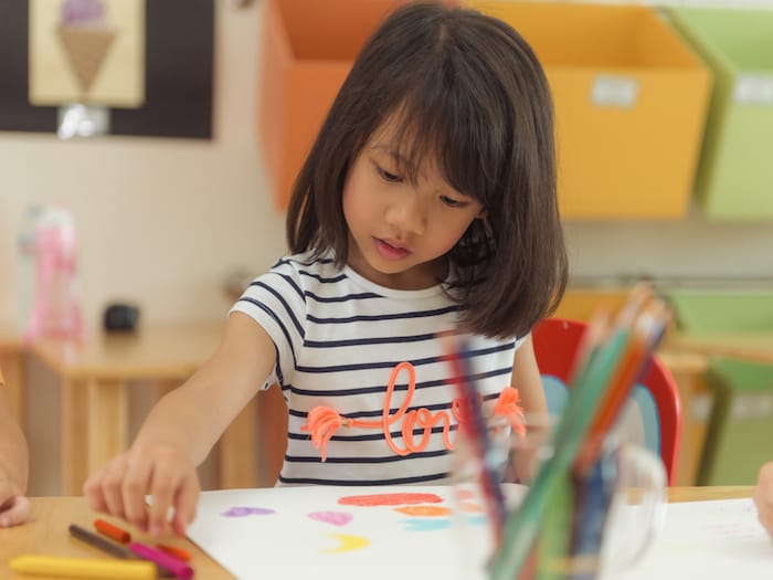 Girl Drawing with Color Pencils