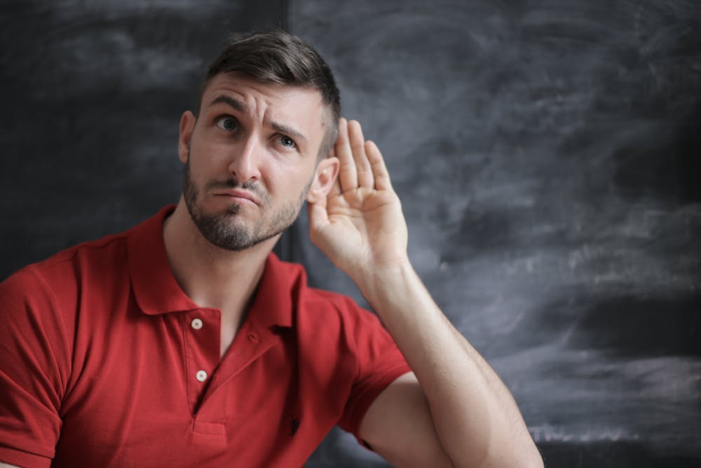 man experiencing early signs of hearing loss